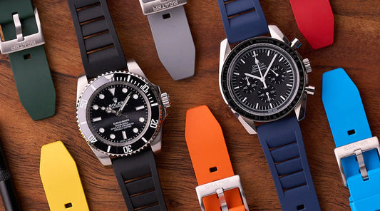 Three Galaxy Watch bands in Australia — FKM rubber, leather, and NATO — laid flat beside a Samsung Galaxy Watch