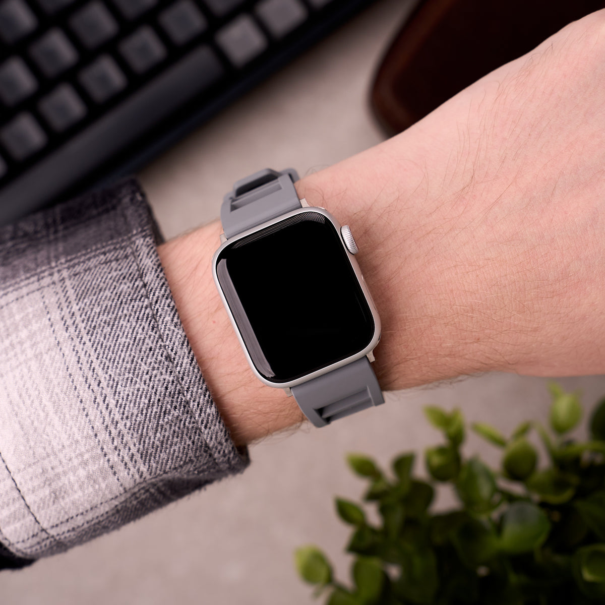 The Bastion FKM rubber Apple Watch band in Grey worn on the wrist with an Apple Watch