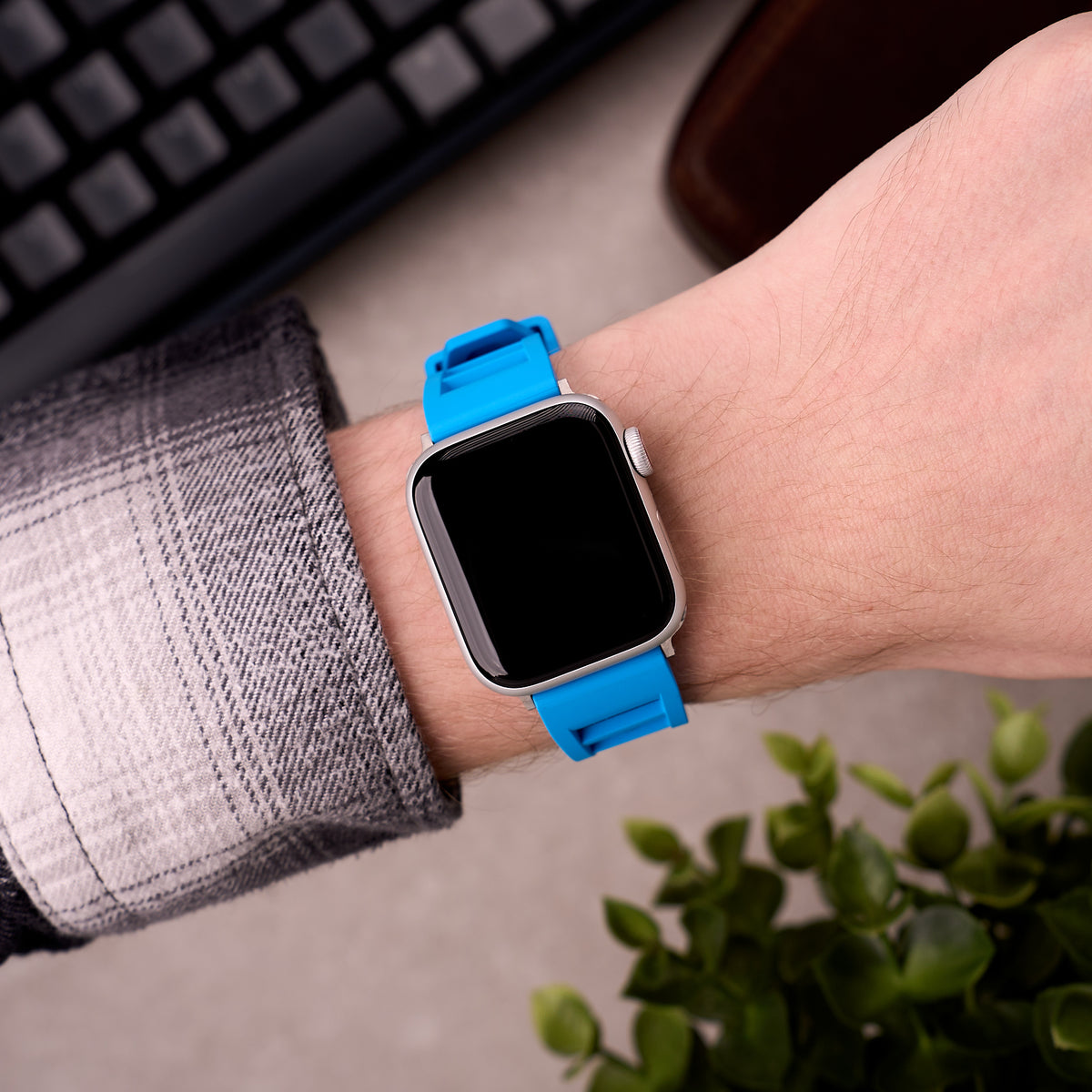 The Bastion FKM rubber Apple Watch band in Light Blue worn on the wrist with an Apple Watch