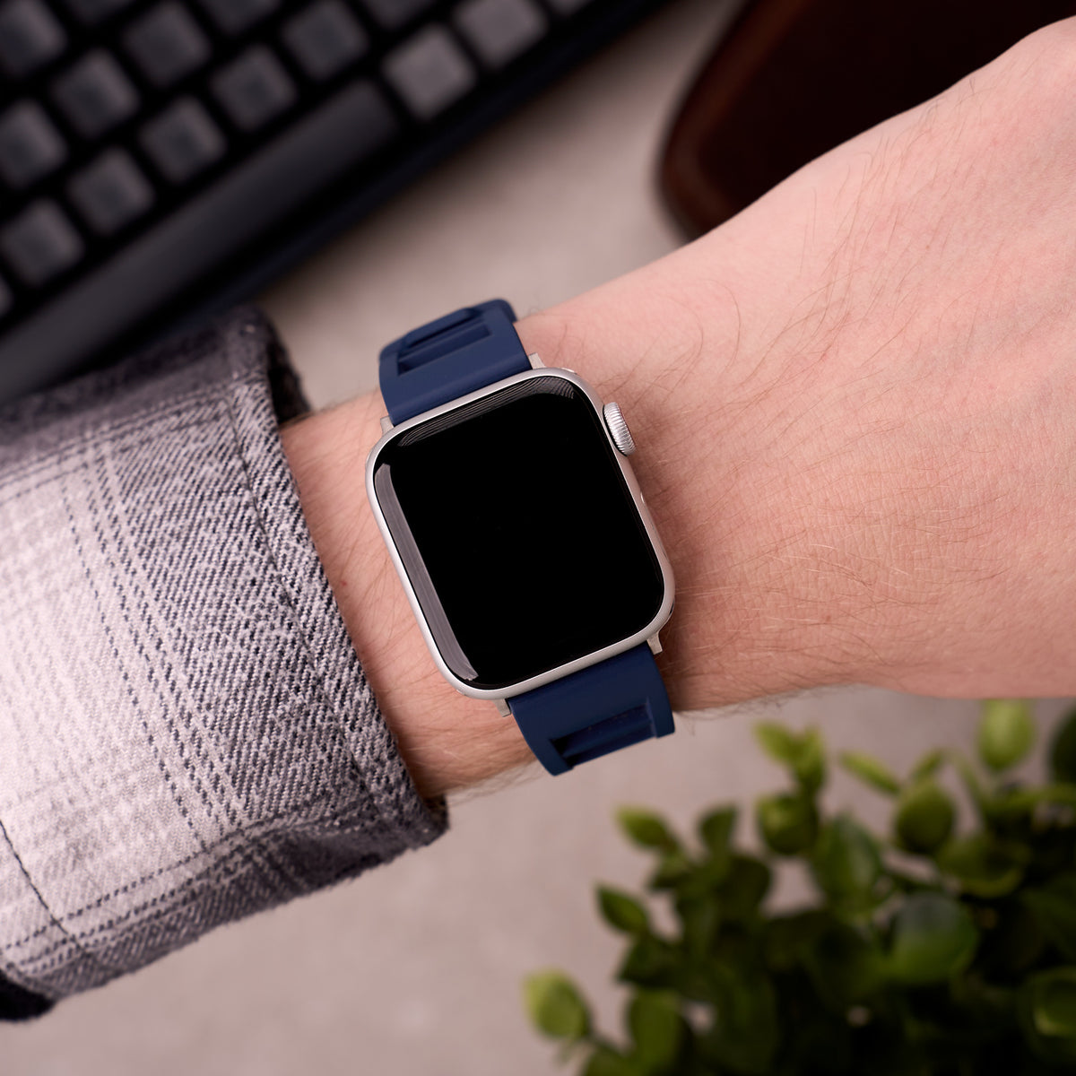The Bastion FKM rubber Apple Watch band in Navy Blue worn on the wrist with an Apple Watch