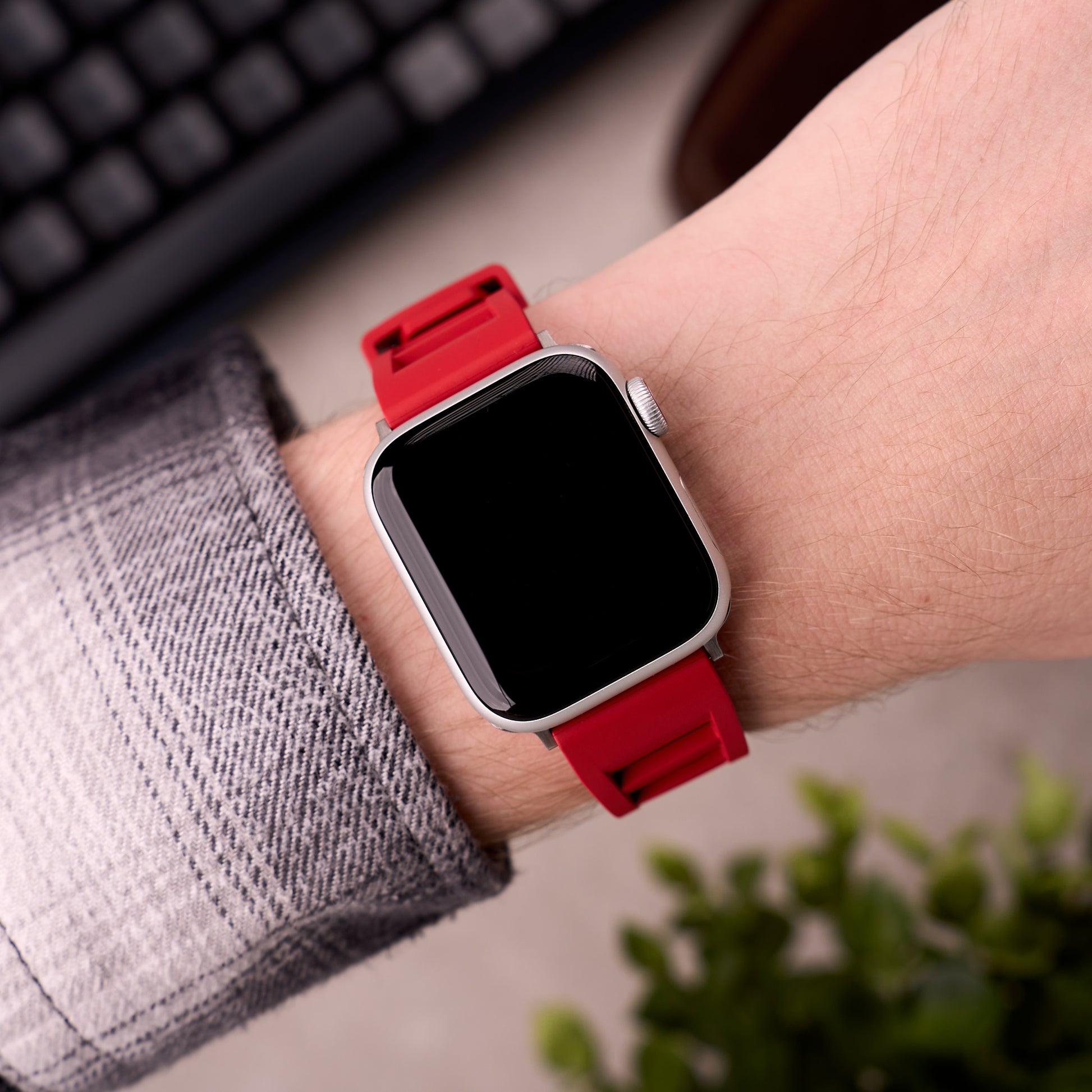 The Bastion FKM rubber Apple Watch band in Red worn on the wrist with an Apple Watch
