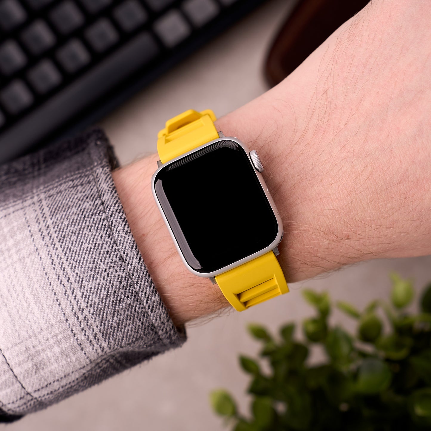 The Bastion FKM rubber Apple Watch band in Yellow worn on the wrist with an Apple Watch