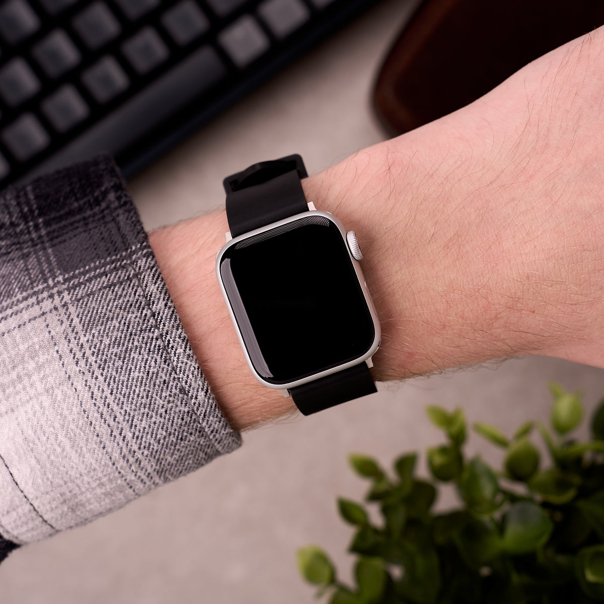 The Callaway FKM rubber Apple Watch band in Black worn on the wrist with an Apple Watch