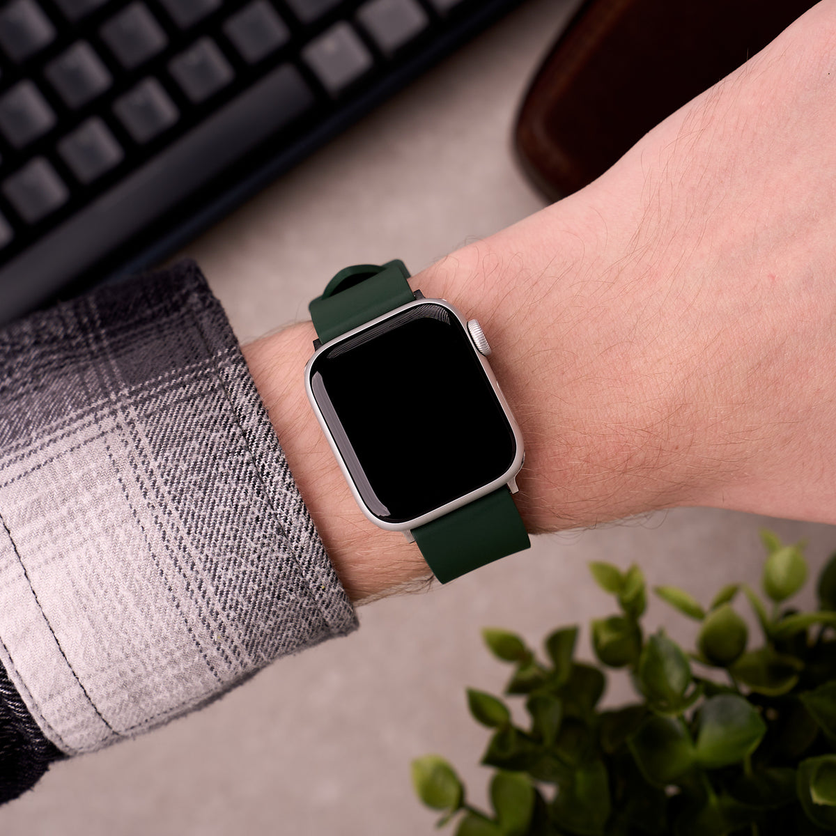The Callaway FKM rubber Apple Watch band in Forest Green worn on the wrist with an Apple Watch