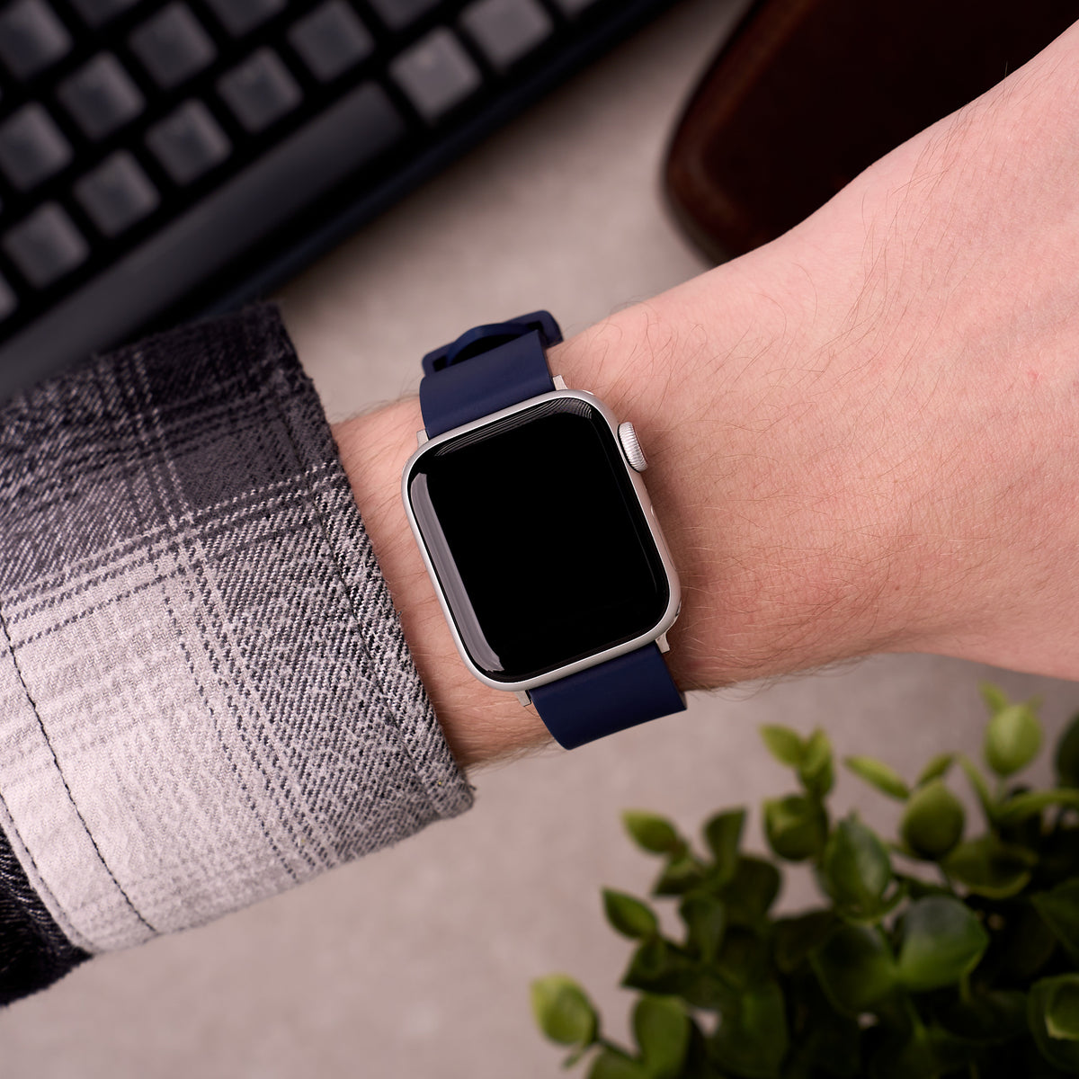 The Callaway FKM rubber Apple Watch band in Navy Blue worn on the wrist with an Apple Watch