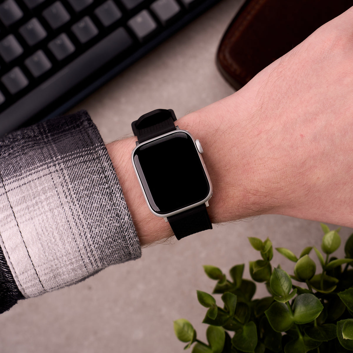 The Gatton FKM rubber Apple Watch band in Black worn on the wrist with an Apple Watch
