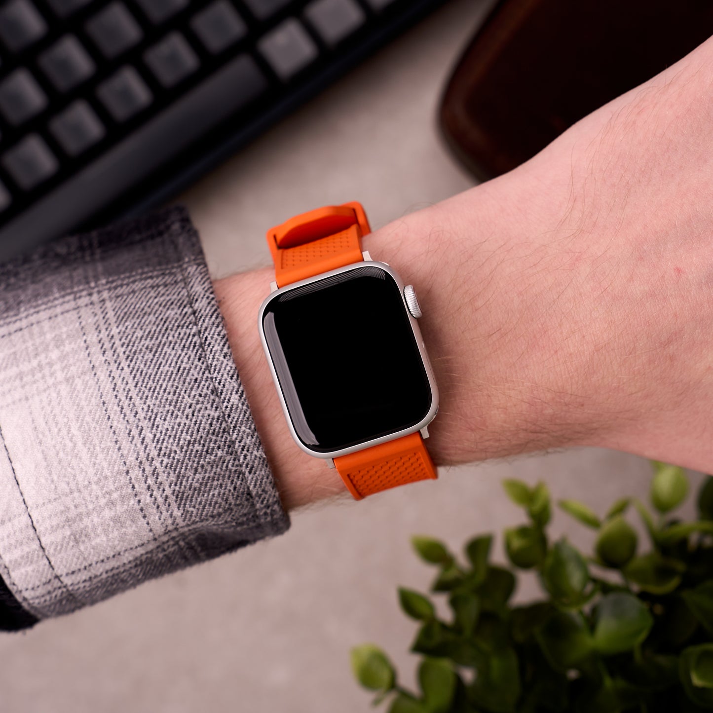 The Gatton FKM rubber Apple Watch band in Orange worn on the wrist with an Apple Watch