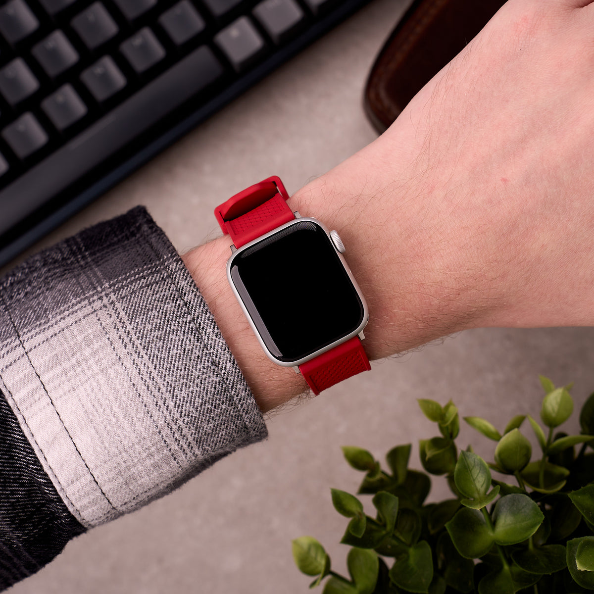 The Gatton FKM rubber Apple Watch band in Red worn on the wrist with an Apple Watch