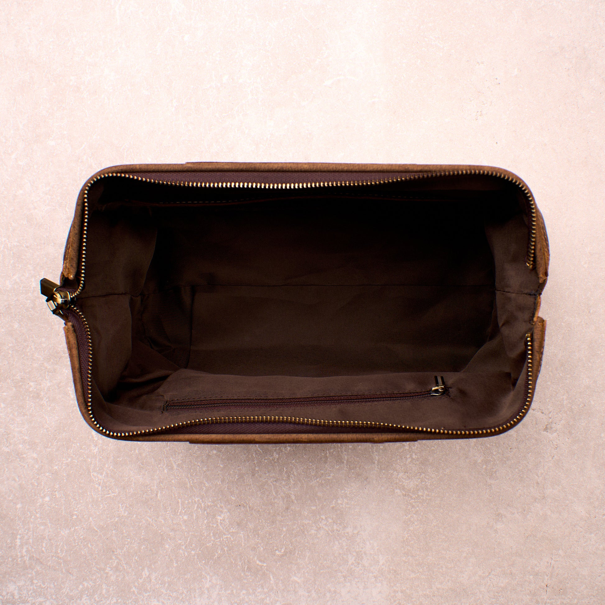 The Grafton toiletry bag open and empty, showing the wide opening and lined interior