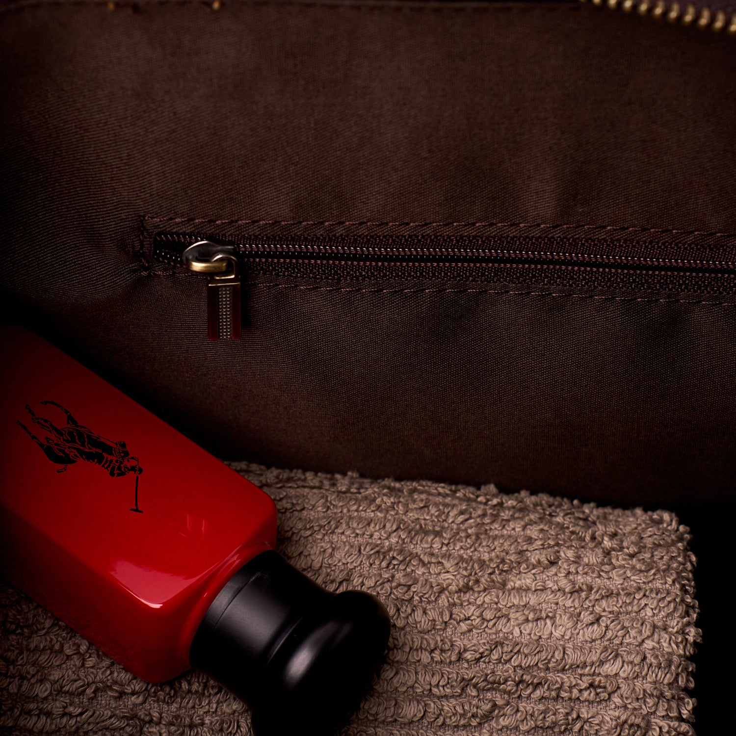 Detail of the full width zipped inner pocket inside The Grafton leather toiletry bag