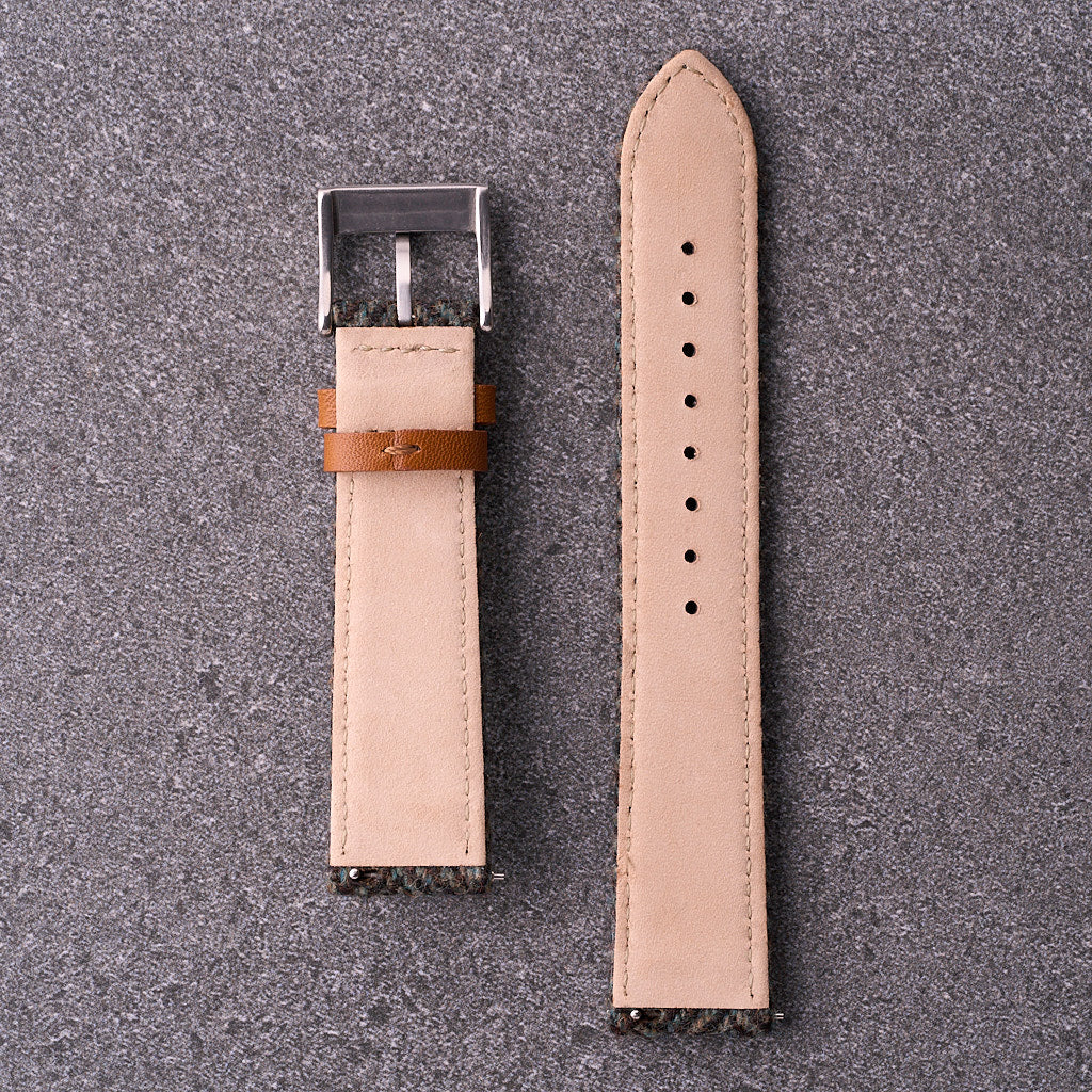 Underside view of The Hamilton forest green tweed strap showing soft leather backing and punched holes for multiple wrist sizes.