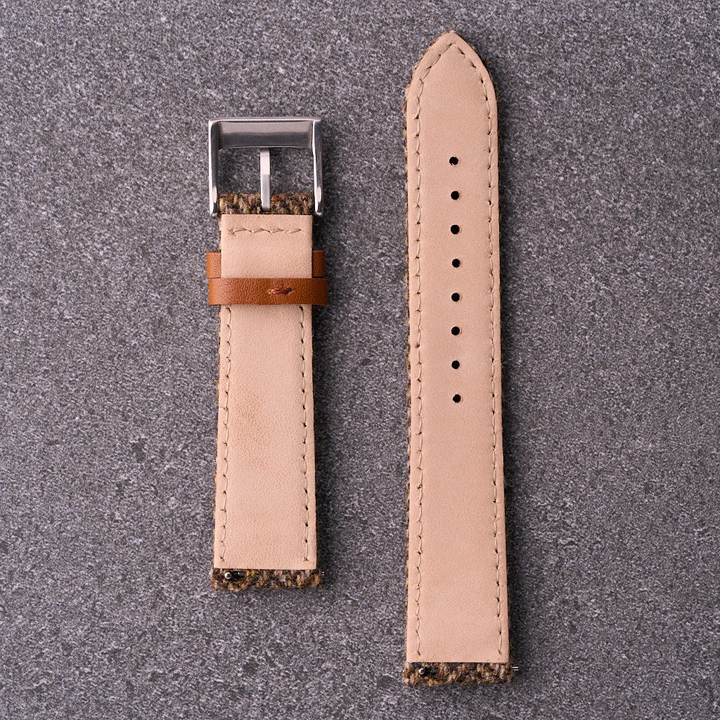 Underside close-up of The Hamilton khaki tweed strap showing light leather backing and evenly spaced adjustment holes.