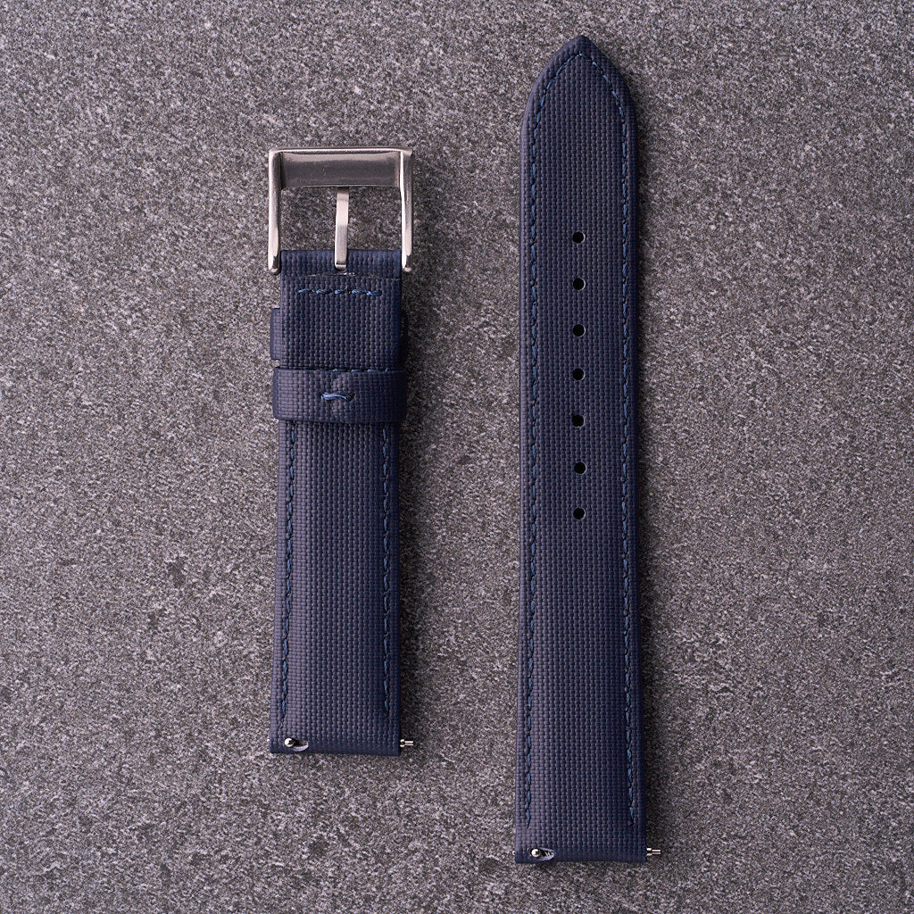 Underside of The Harbour navy blue strap showing curved profile and sizing holes.