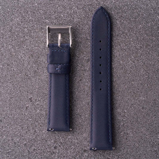 Underside of The Harbour navy blue strap showing curved profile and sizing holes.