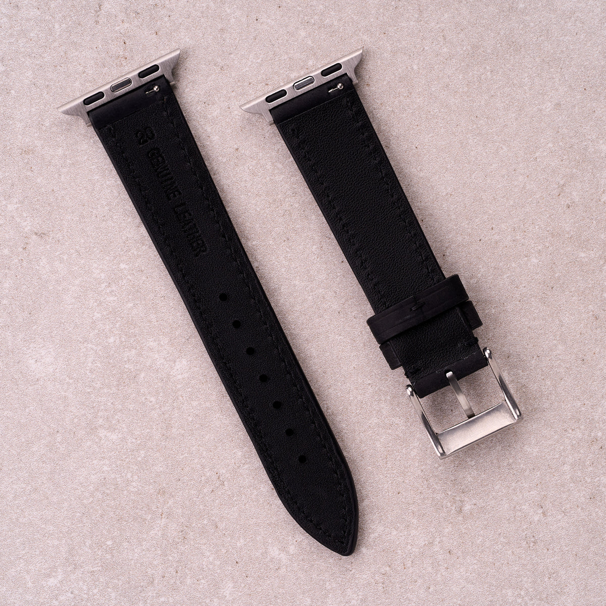 The Harrington leather Apple Watch band in Black, back view showing the quick release pin and strap size marking