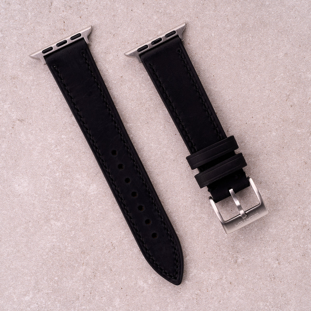 The Harrington leather Apple Watch band in Black, front view showing the full strap and buckle
