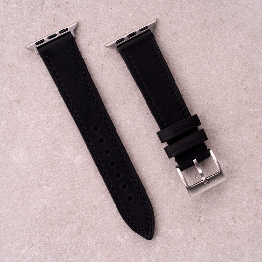 The Harrington leather Apple Watch band in Black, front view showing the full strap and buckle
