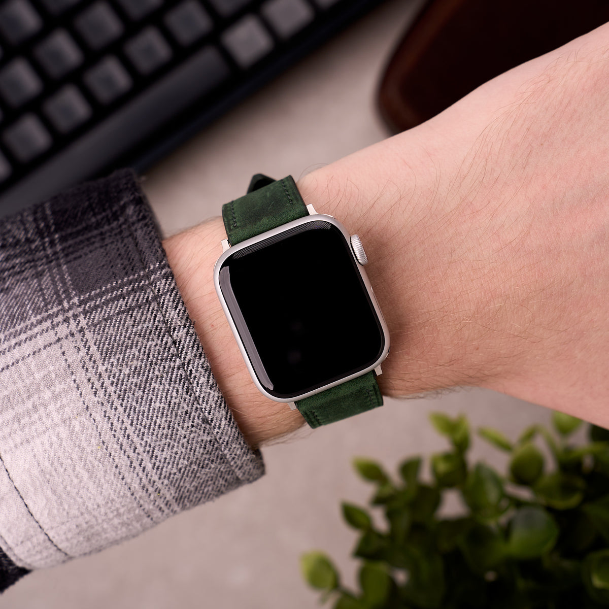 The Harrington leather Apple Watch band in Forest Green worn on the wrist with an Apple Watch