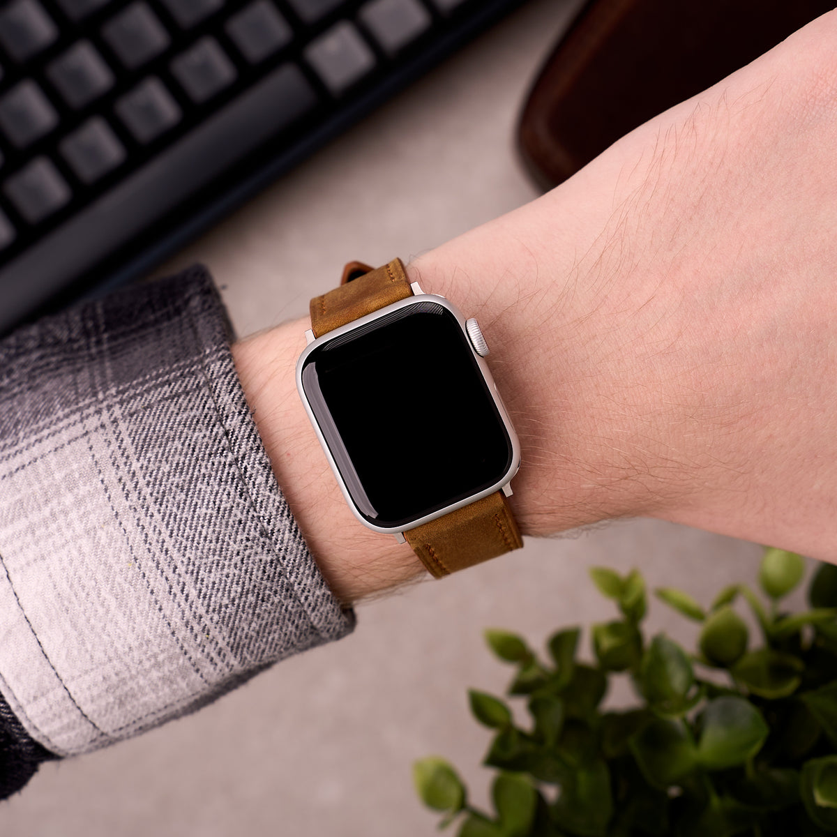 The Harrington leather Apple Watch band in Light Brown worn on the wrist with an Apple Watch