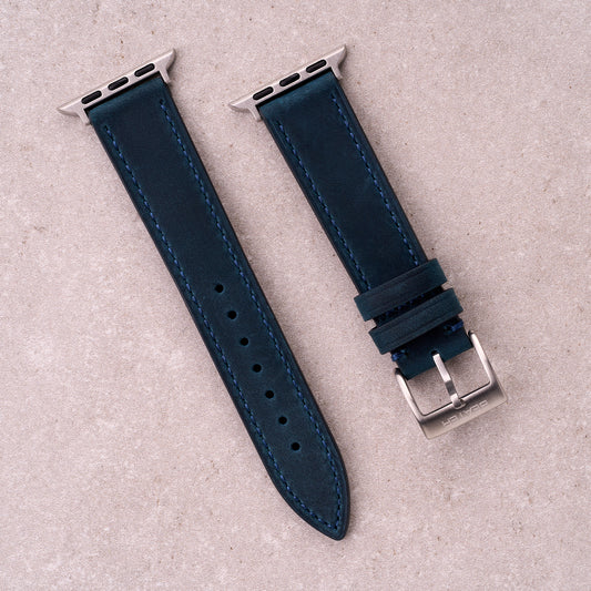 The Harrington leather Apple Watch band in Navy Blue, front view showing the full strap and buckle