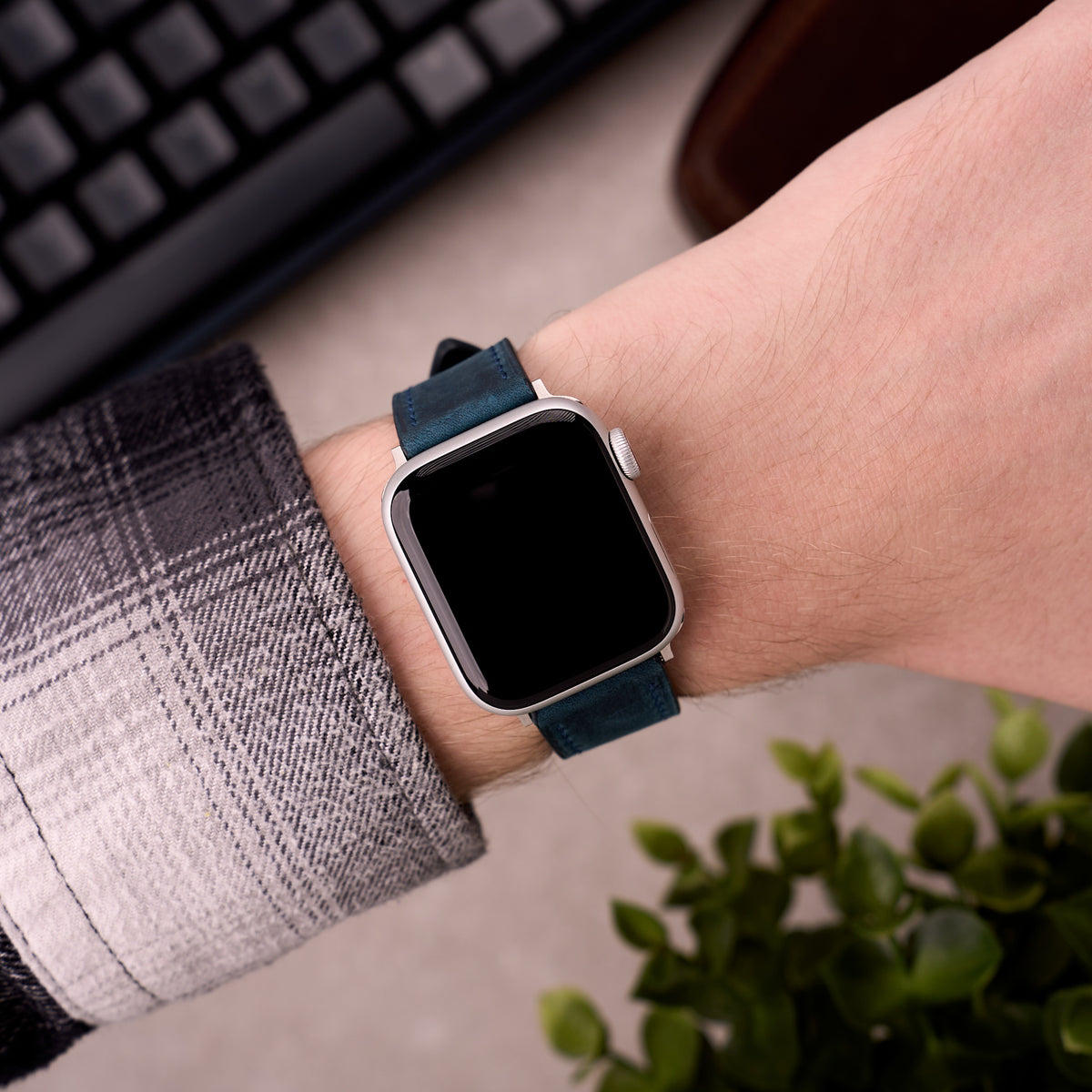 The Harrington leather Apple Watch band in Navy Blue worn on the wrist with an Apple Watch