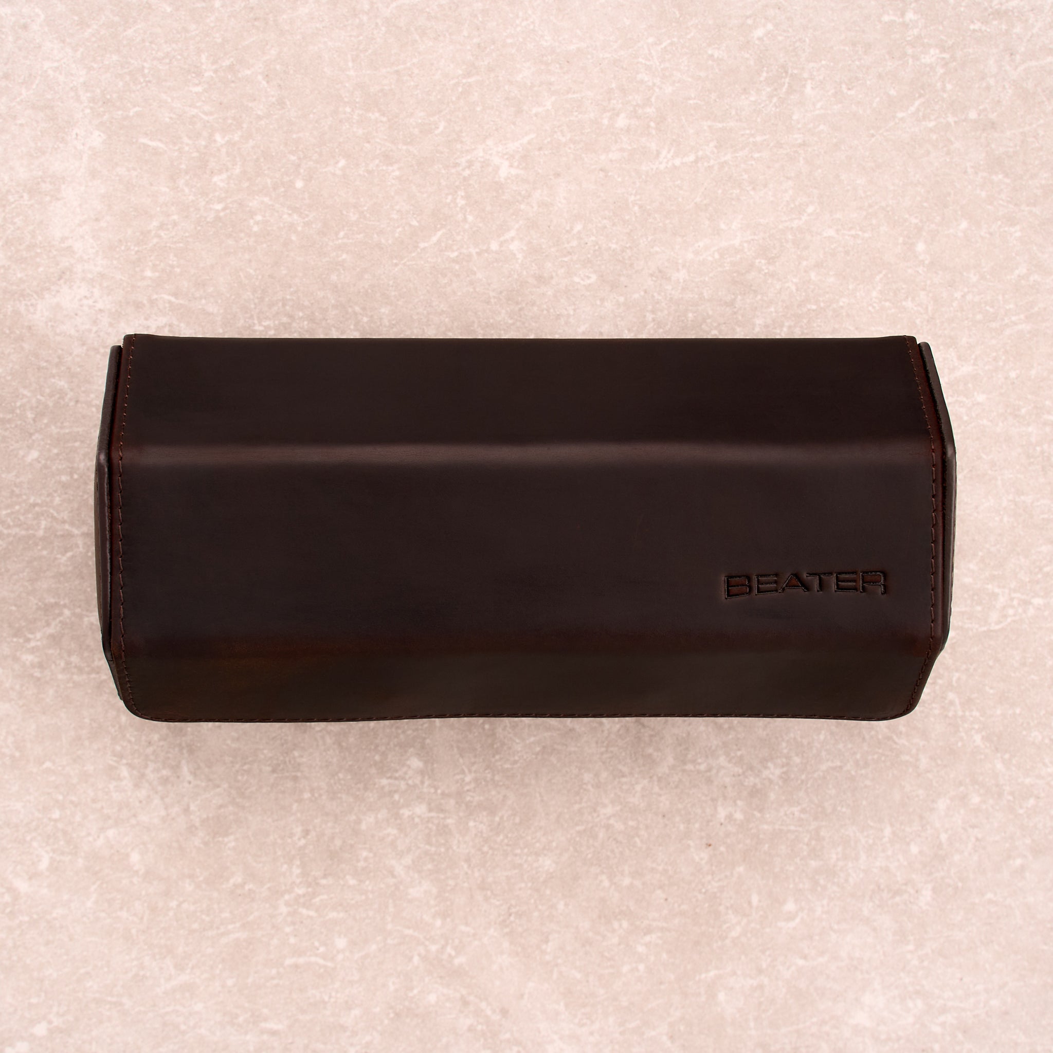 The Ashford leather watch roll closed, shot top down, with the Beater logo embossed on the lid