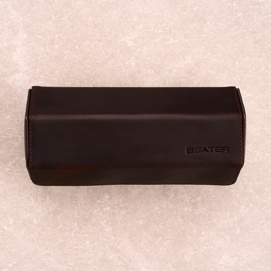 The Ashford leather watch roll closed, shot top down, with the Beater logo embossed on the lid