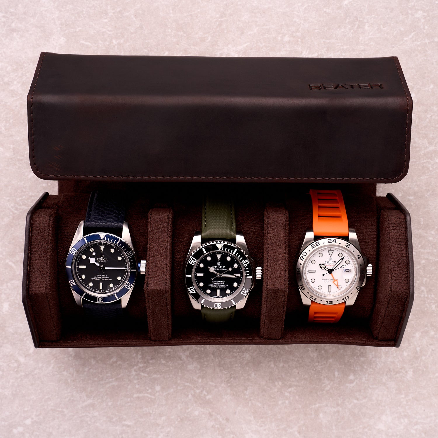 The Ashford watch roll open with three watches resting in its suede lined slots