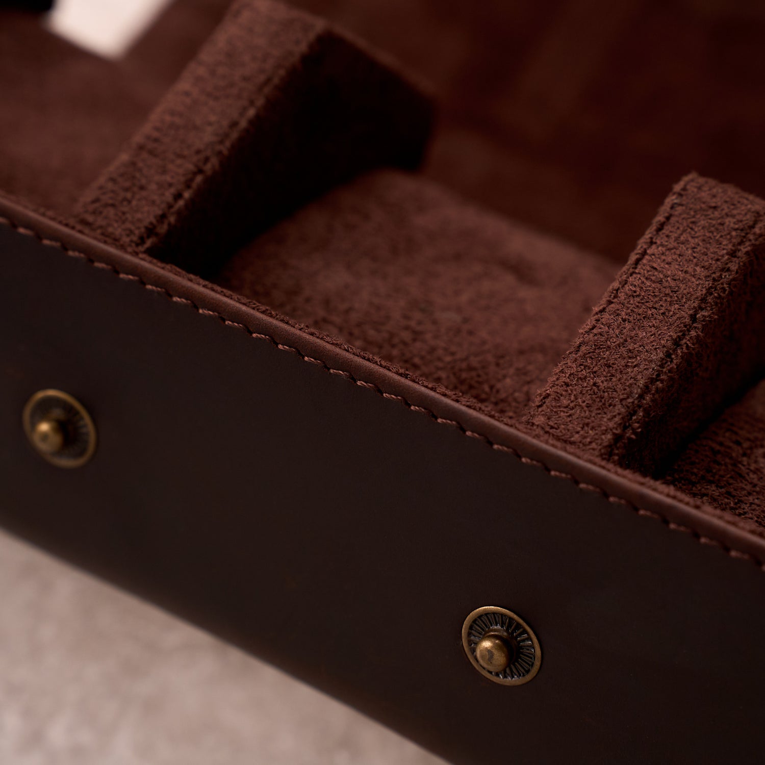 Interior detail of The Ashford watch roll showing the suede pillows and brass stud closure