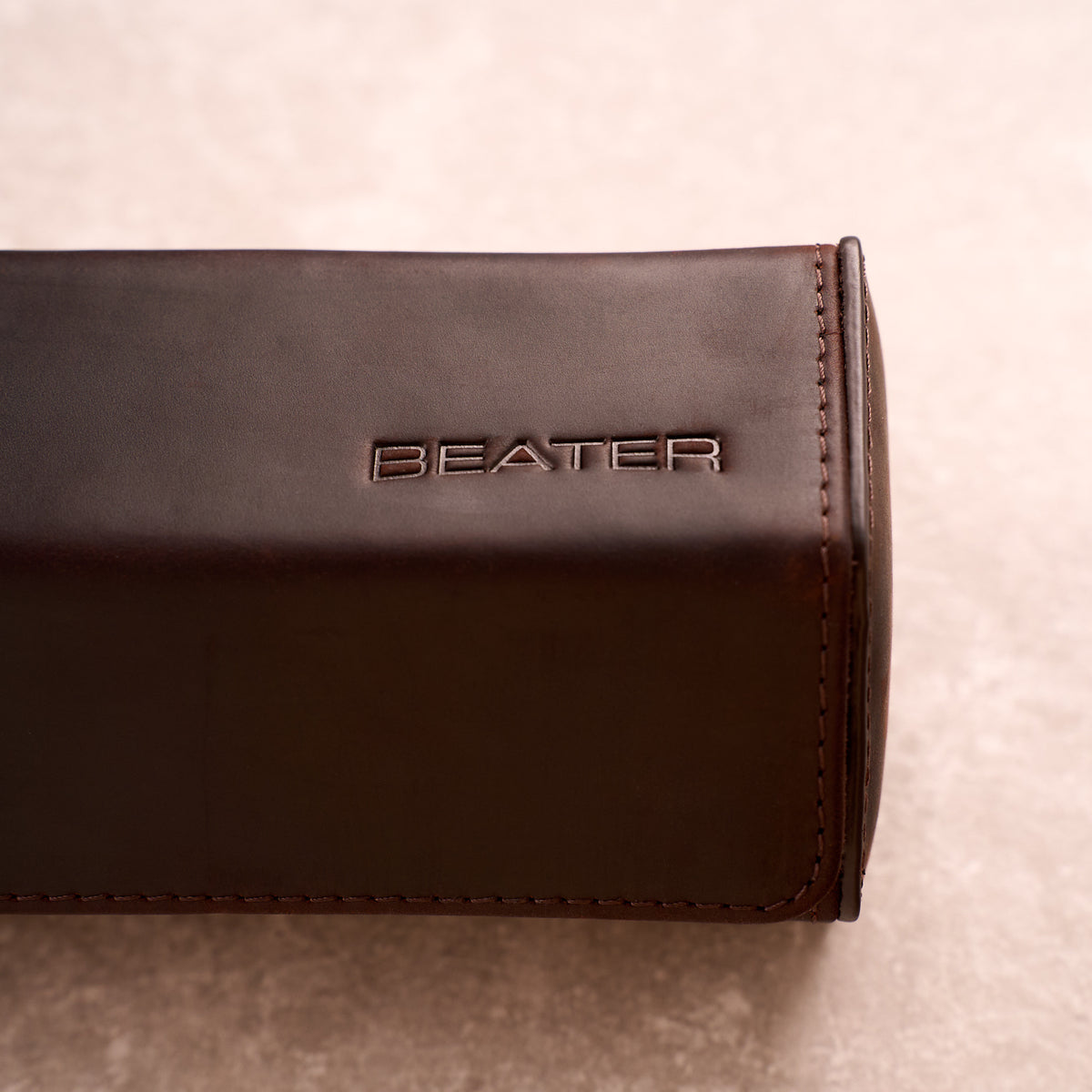 Close up of the Beater logo embossed into the leather of The Ashford watch roll