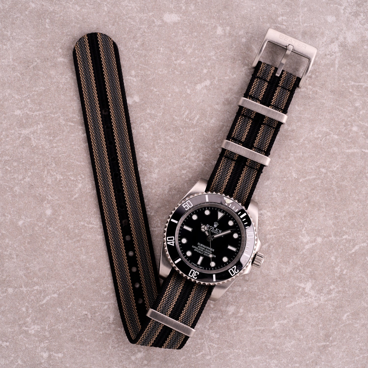 The Operator black khaki and grey stripe NATO strap, striped nylon one-piece watch band with brushed hardware for tactical watches.