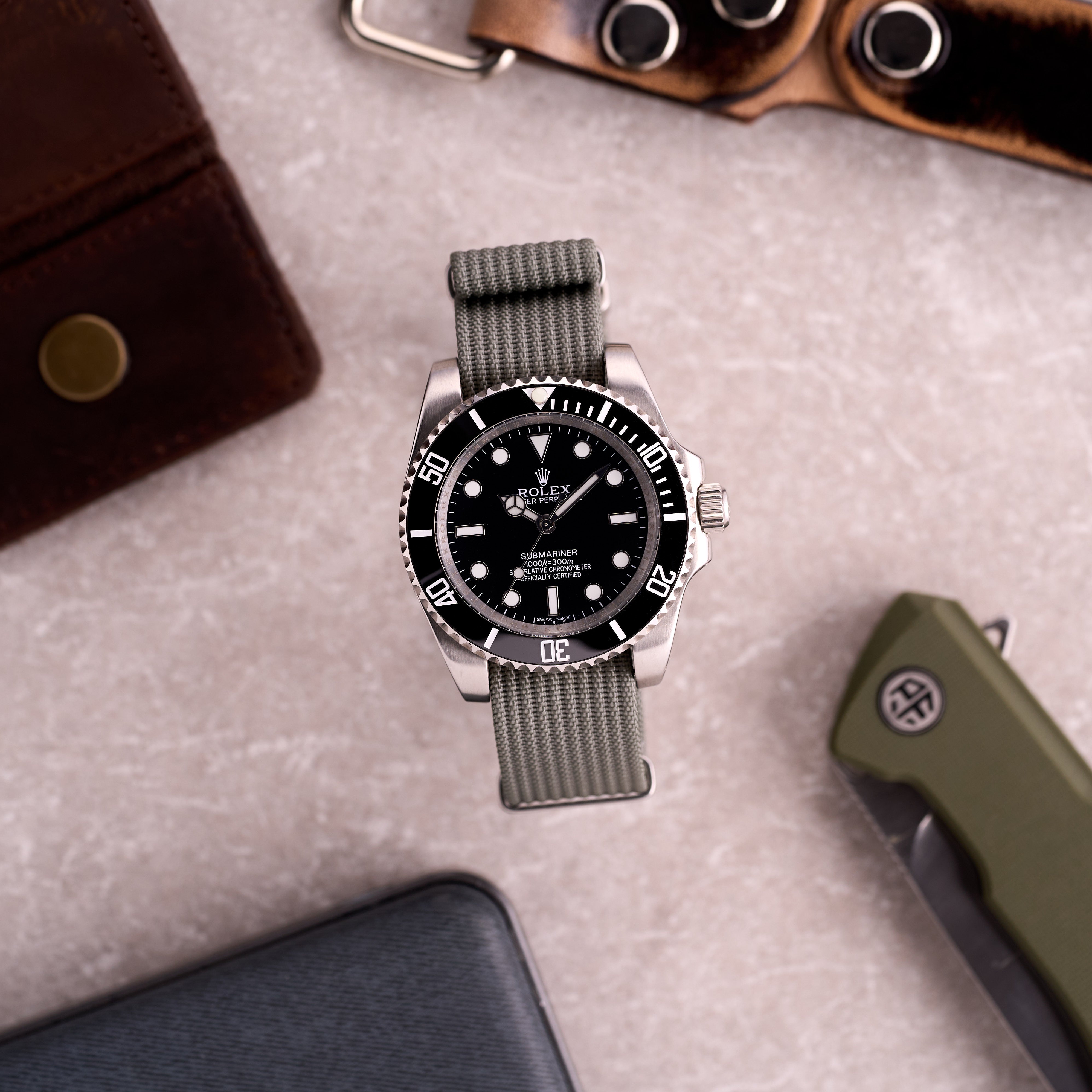 Watch on The Operator light grey corrugated NATO strap in a lifestyle scene, showcasing the neutral grey colour on wrist.