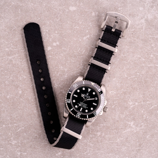 The Sentinel black with grey edge NATO strap, seatbelt nylon one-piece watch strap with subtle grey border and steel hardware.