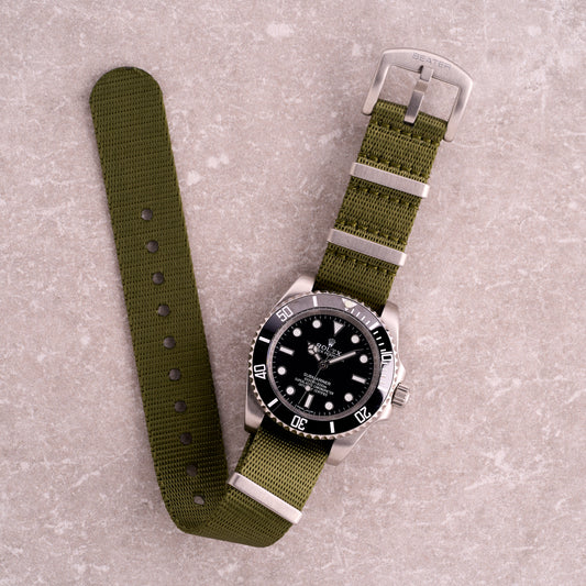 The Sentinel green seatbelt NATO strap, premium deep green nylon one-piece watch band with brushed stainless hardware for field and sport watches.