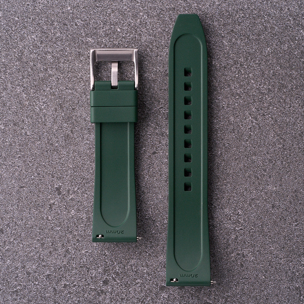 Underside of The Specter army green strap showing lined rubber surface and pin holes.