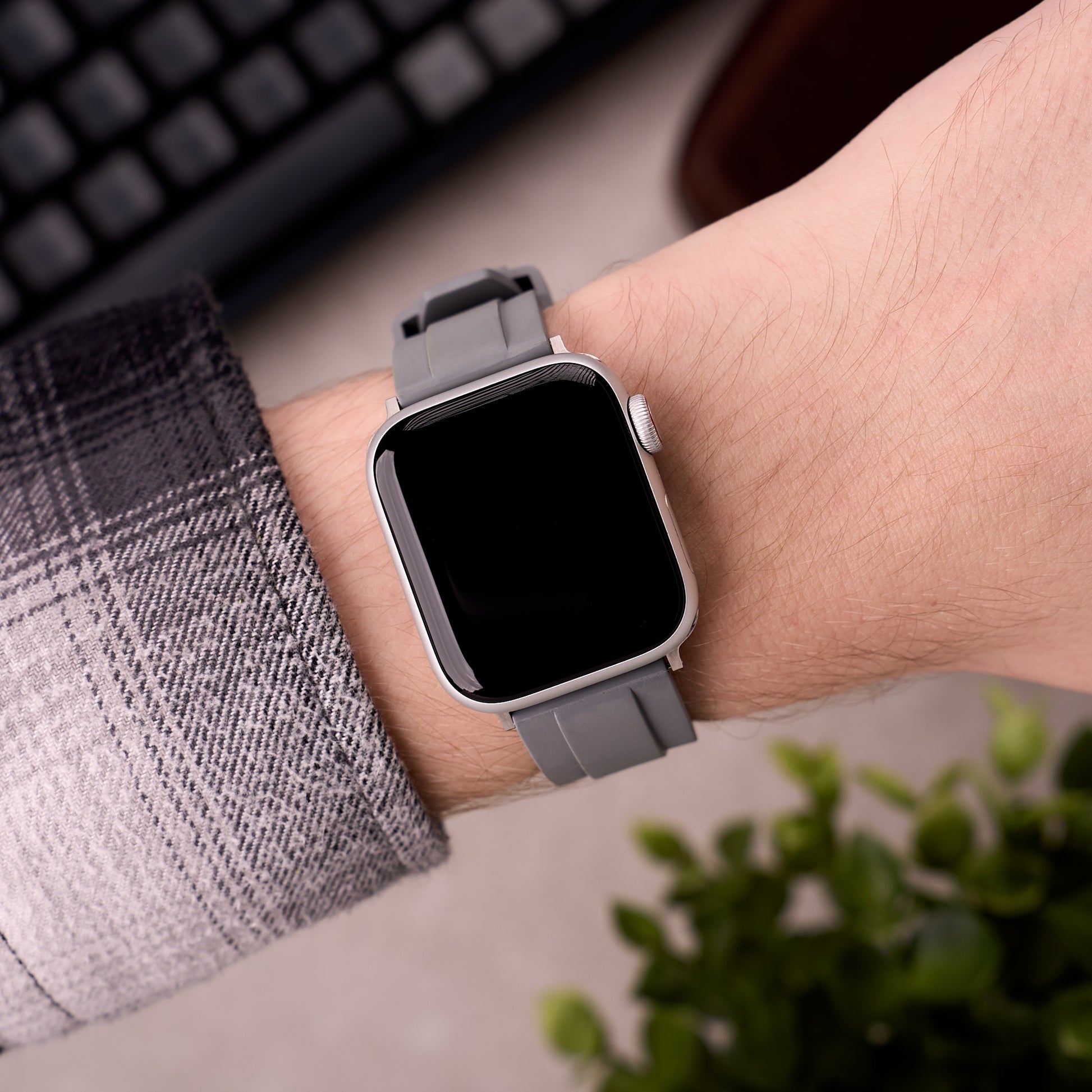The Specter FKM rubber Apple Watch band in Grey worn on the wrist with an Apple Watch