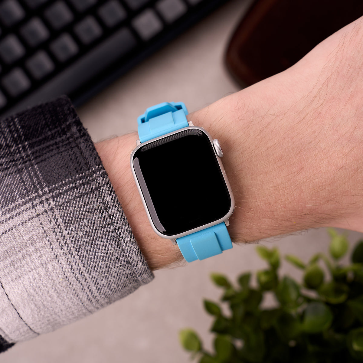 The Specter FKM rubber Apple Watch band in Light Blue worn on the wrist with an Apple Watch