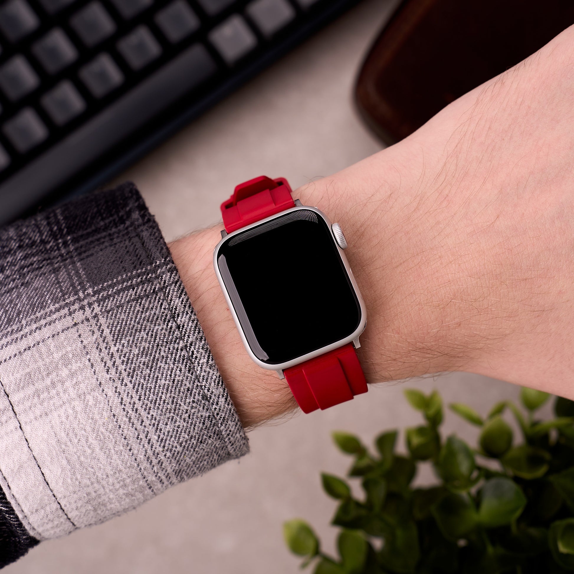 The Specter FKM rubber Apple Watch band in Red worn on the wrist with an Apple Watch