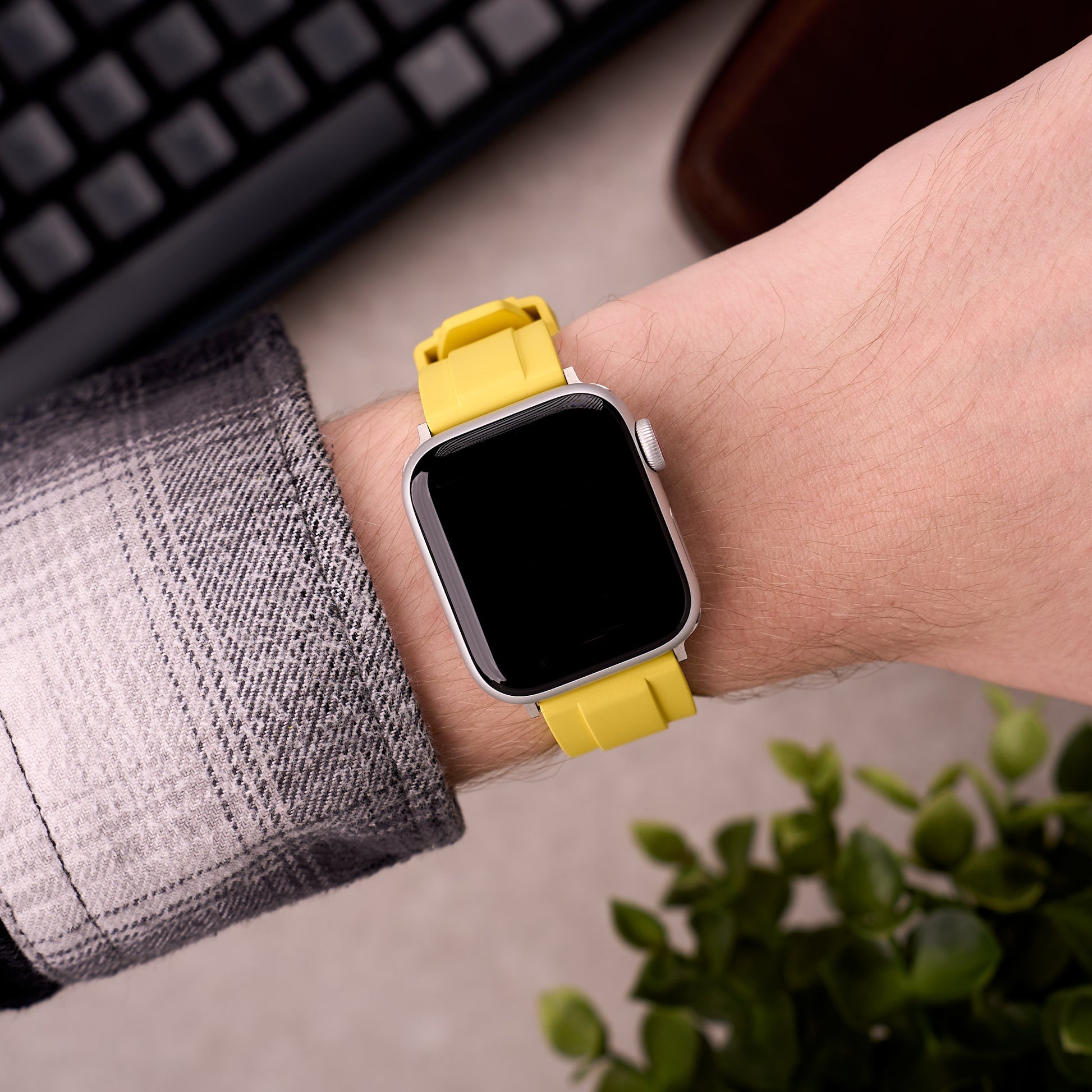 The Specter FKM rubber Apple Watch band in Yellow worn on the wrist with an Apple Watch