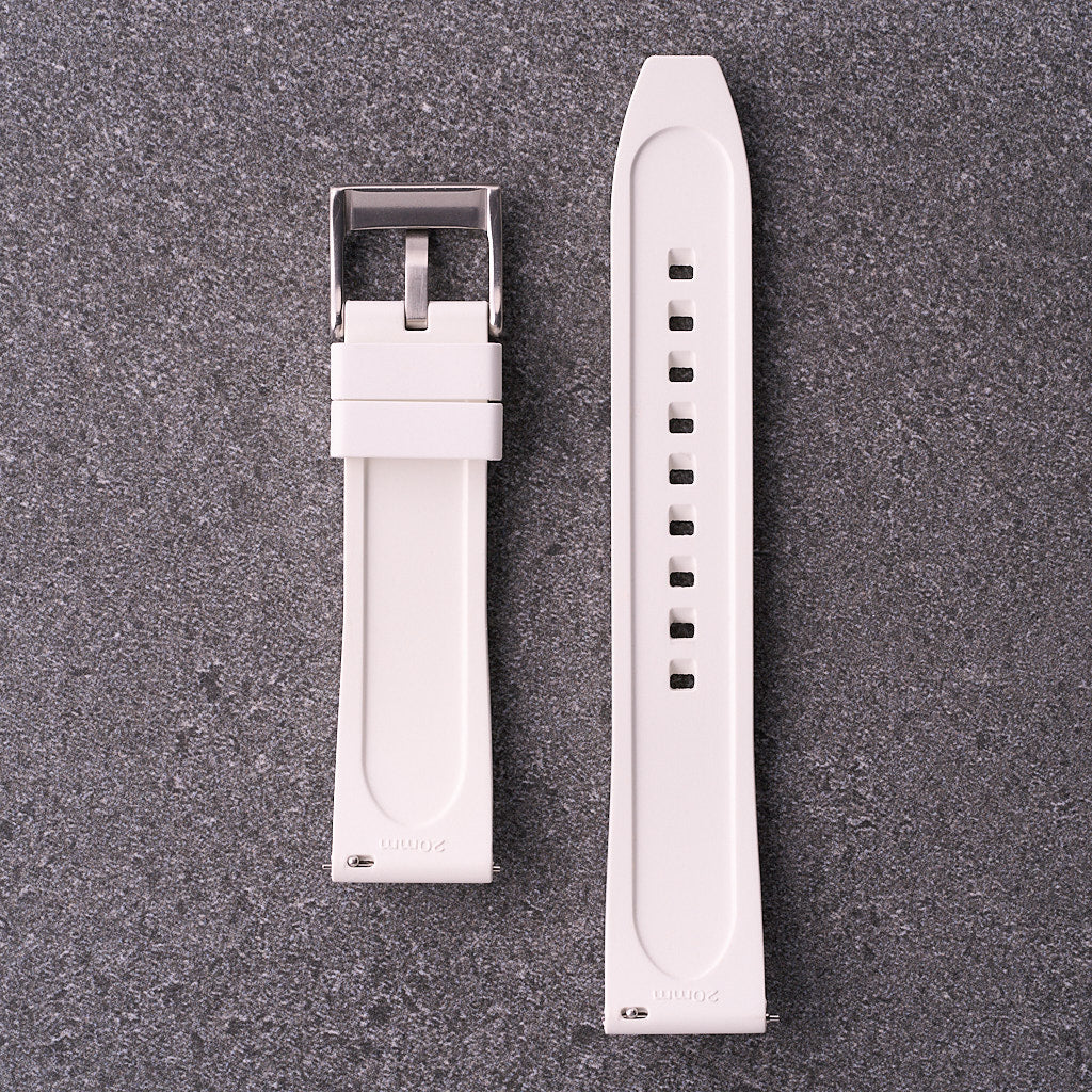Underside of The Specter white strap showing contoured rubber backing and buckle hardware.