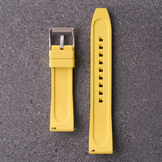 Underside of The Specter yellow strap showing contoured rubber back and punched holes.