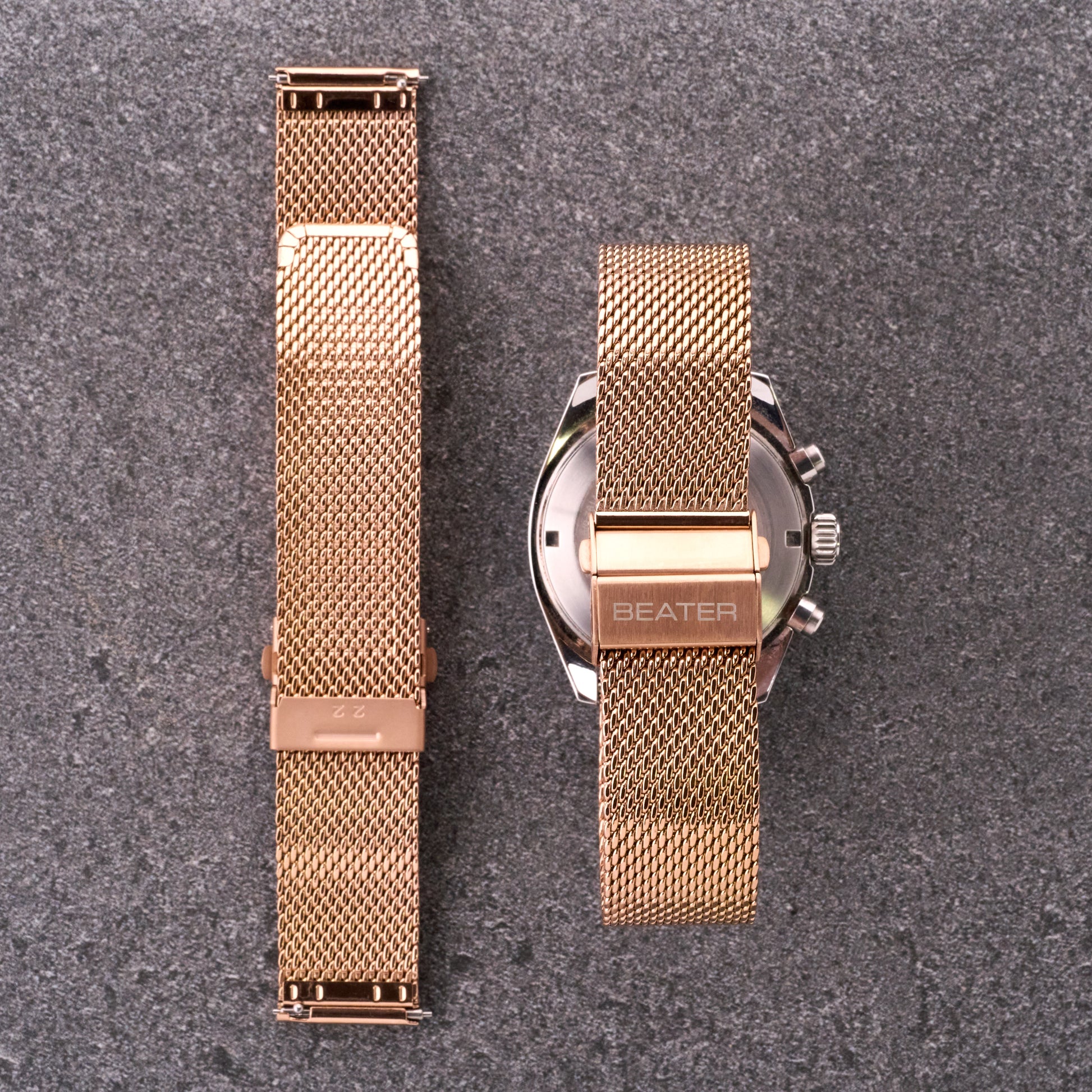 The Sterling bronze rose mesh stainless steel bracelet displayed front and back beside a watch, showing mesh pattern and clasp arrangement.​