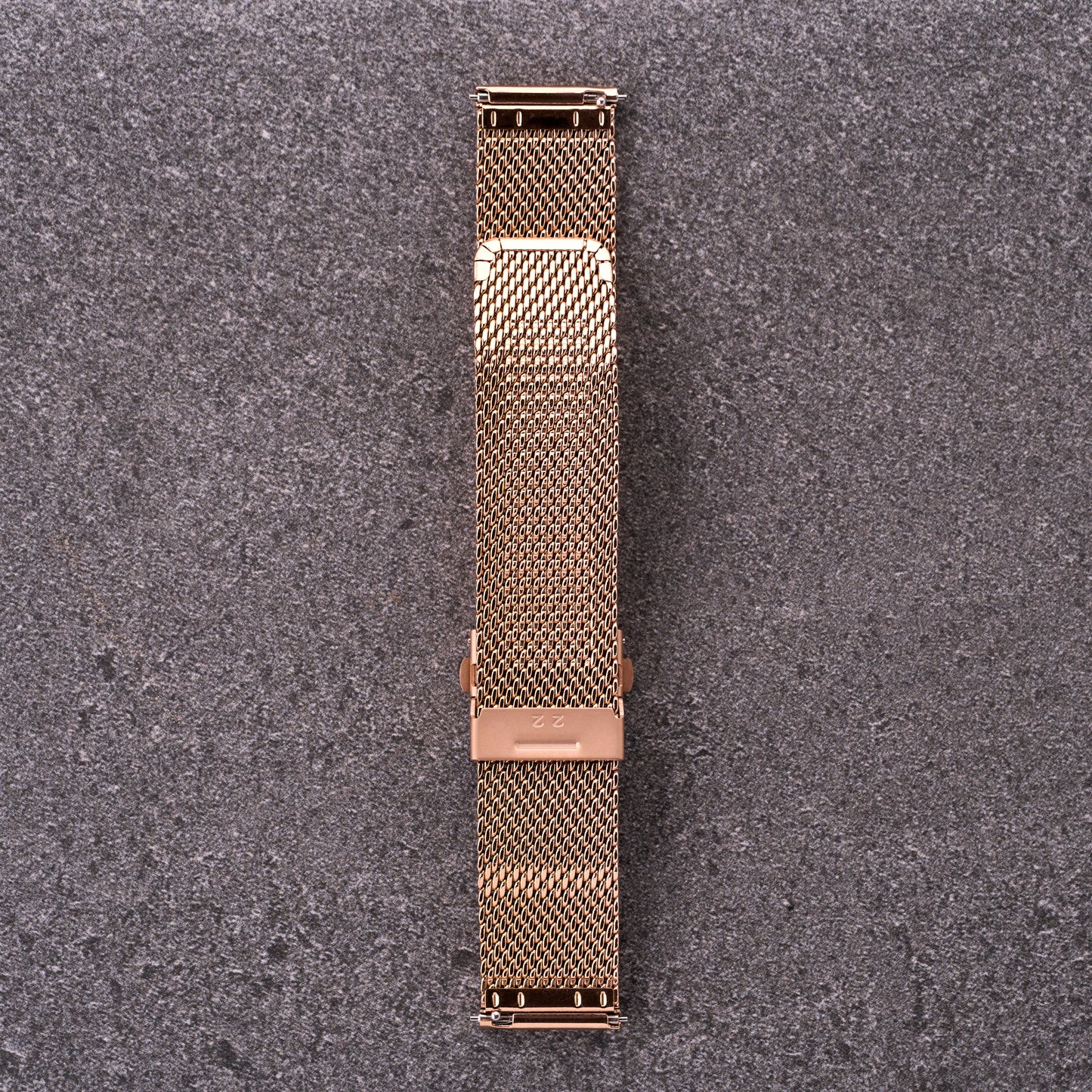 The Sterling bronze rose mesh stainless steel strap laid out flat, showing curved end links and adjustable mesh clasp system.