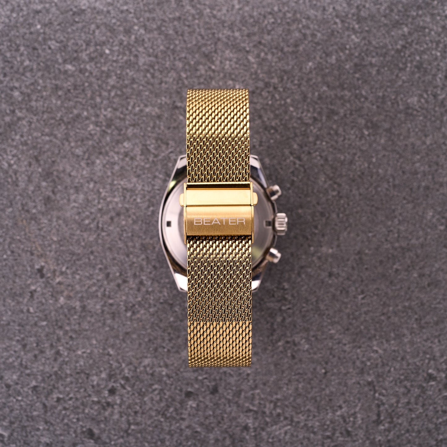 Close-up of The Sterling gold mesh bracelet clasp with engraved logo, focusing on secure folding buckle and tight mesh weave.