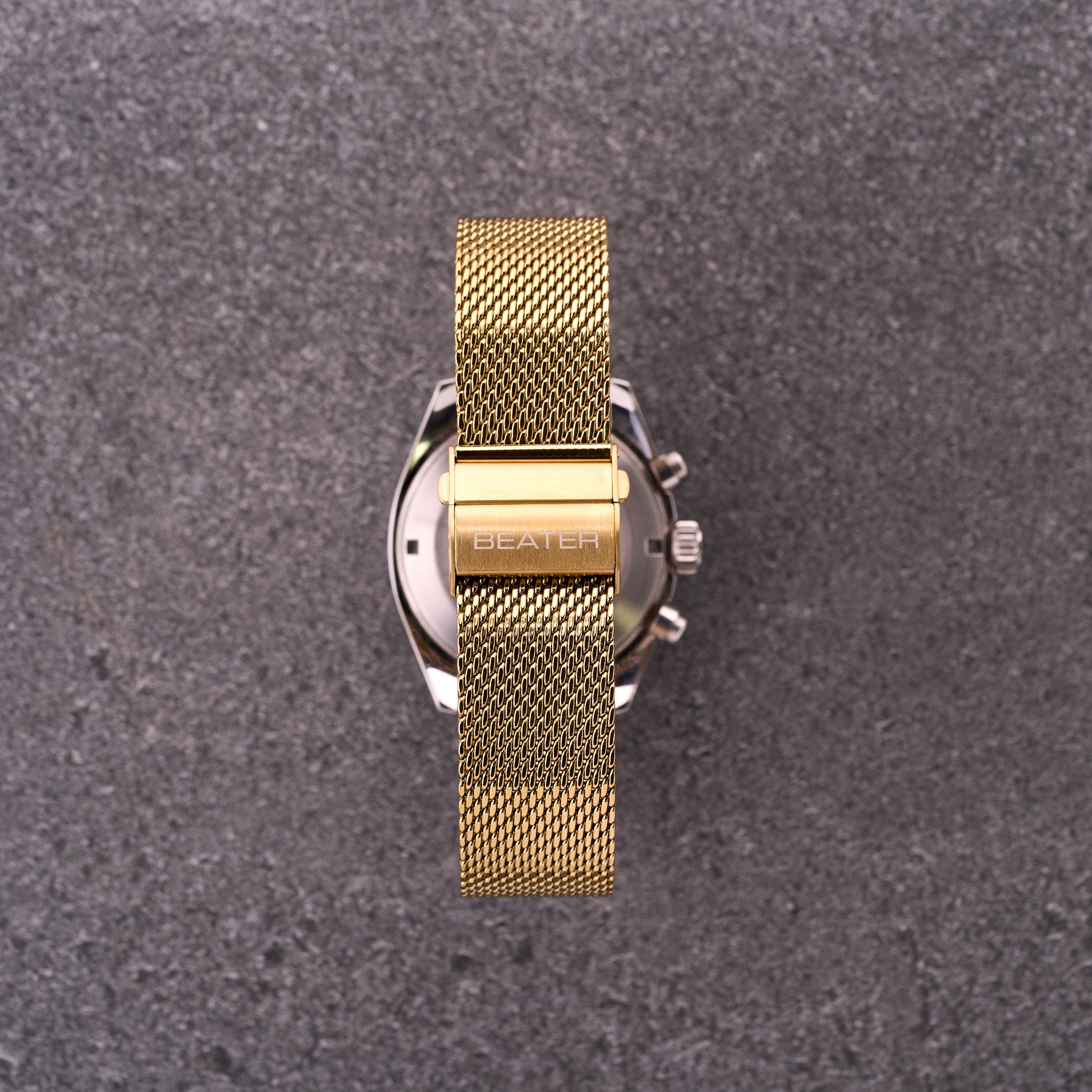 Close-up of The Sterling gold mesh bracelet clasp with engraved logo, focusing on secure folding buckle and tight mesh weave.