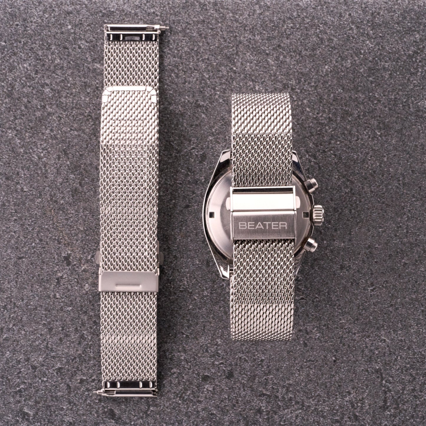 The Sterling silver mesh stainless steel bracelet shown front and back next to a watch, displaying mesh texture and clasp placement.