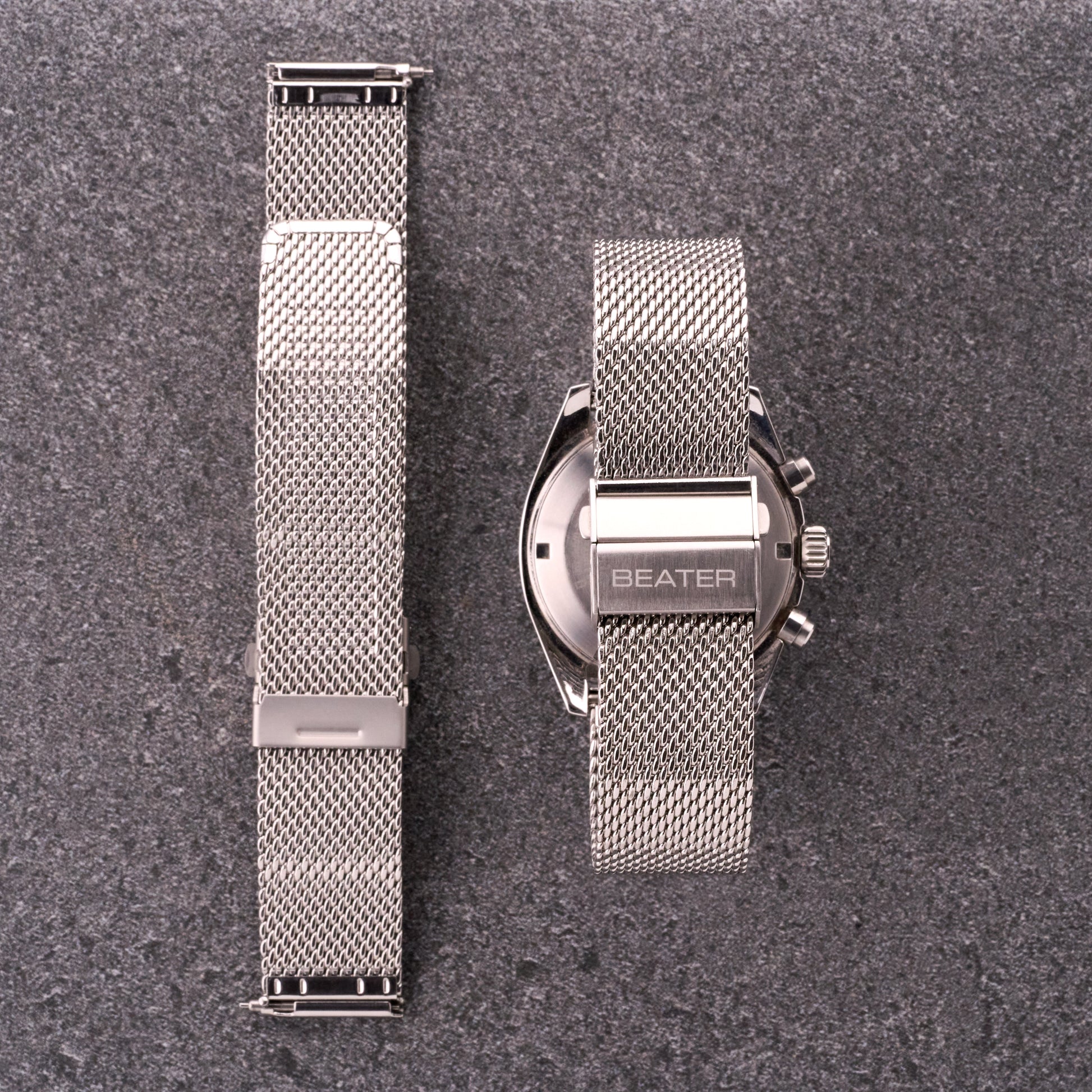 The Sterling silver mesh stainless steel bracelet shown front and back next to a watch, displaying mesh texture and clasp placement.