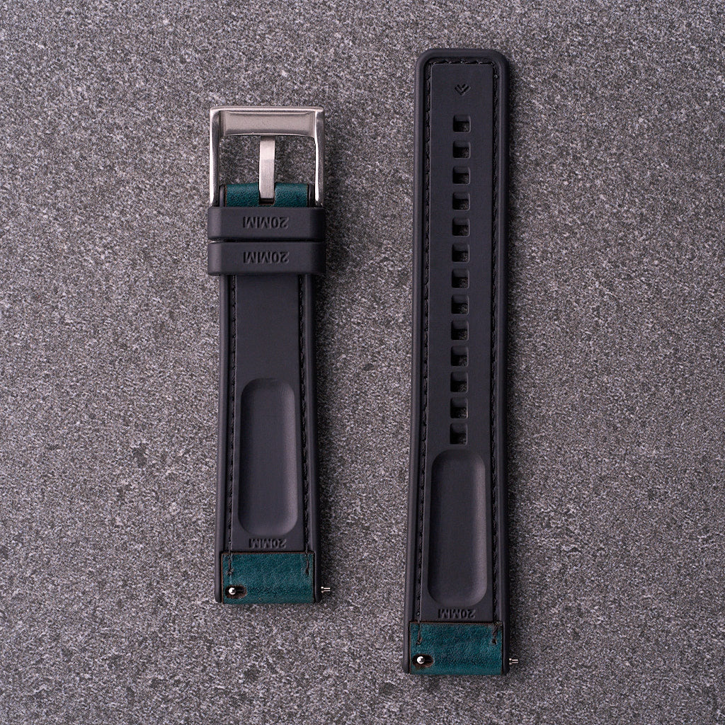 Underside of The Tailor blue strap showing flexible black FKM rubber backing and quick-release hardware.​
