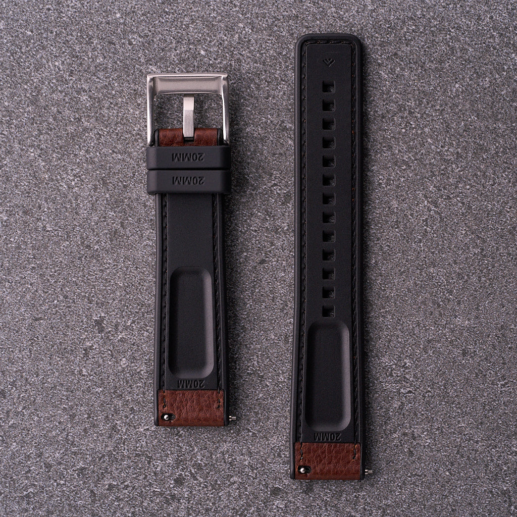 Underside of The Tailor brown strap showing black FKM rubber lining and quick-release spring bars.​