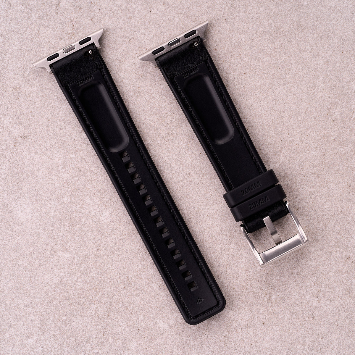 The Tailor leather and FKM rubber Apple Watch band in Black, back view showing the quick release pin and strap size marking